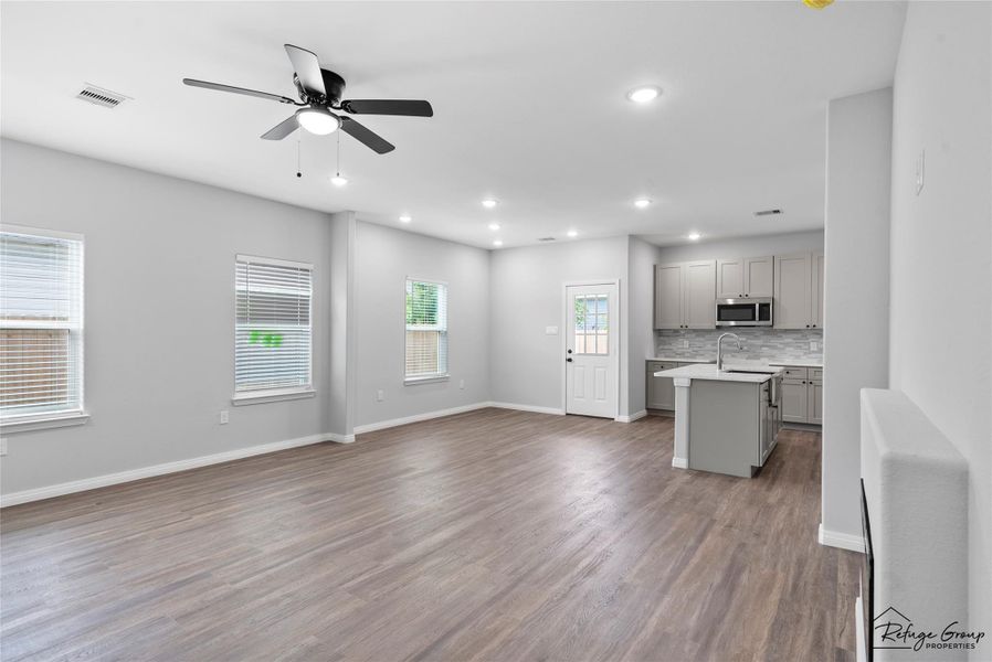 A view from bottom of stairs into the living room and dining room A view from bottom of stairs into the living room and dining room