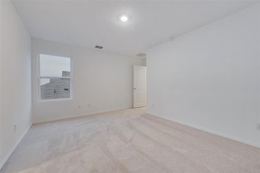 Spare room featuring light colored carpet