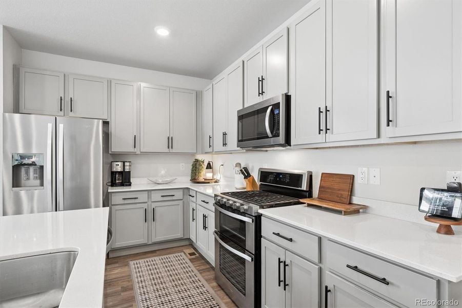 Soft grey cabinets, creamy quartz counters Soft grey cabinets, creamy quartz counters