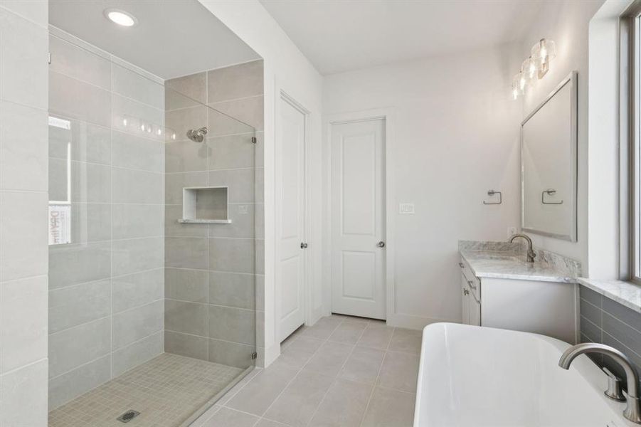 Featuring a spacious walk in shower and free standing tub, this owner's bath is everything you have been searching for.