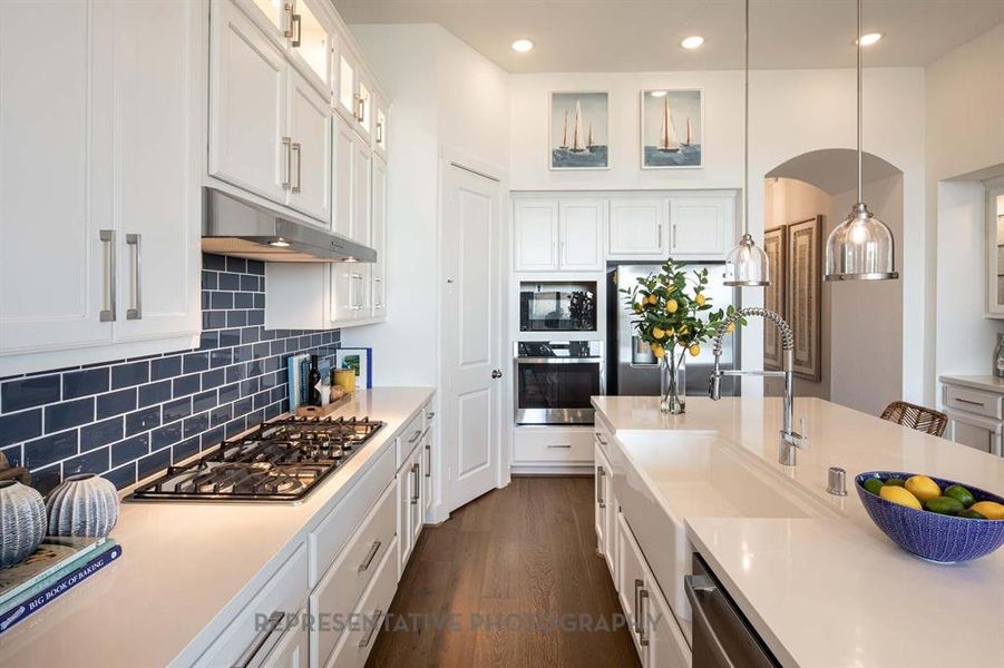 Kitchen featuring white cabinetry, pendant lighting, tasteful backsplash, appliances with stainless steel finishes, and recessed lighting Kitchen featuring white cabinetry, pendant lighting, tasteful backsplash, appliances with stainless steel finishes, and recessed lighting