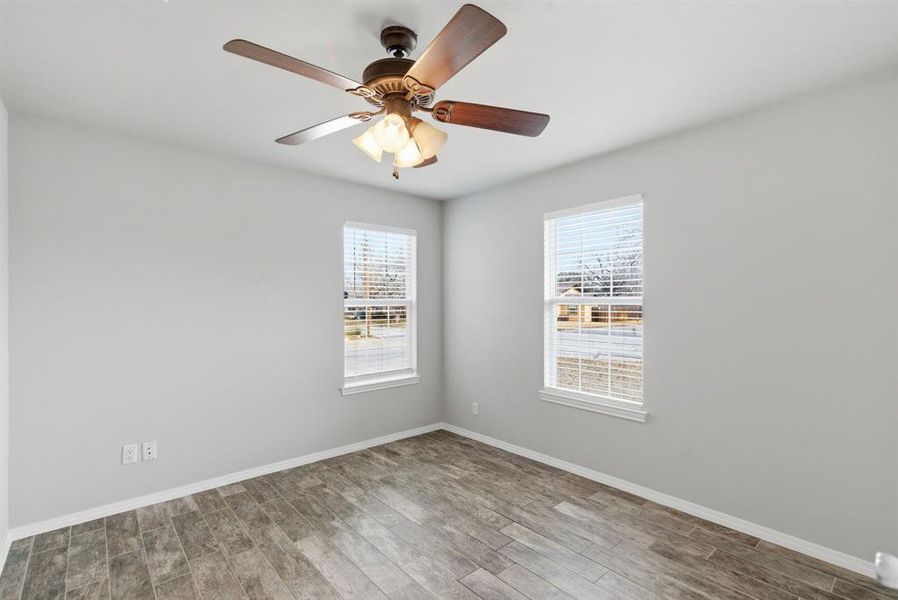 Spare room with wood finished floors and baseboards Spare room with wood finished floors and baseboards