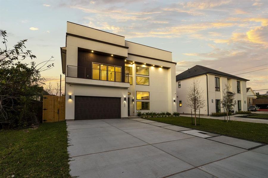 Experience modern luxury in this newly constructed home located on a rapidly developing street in Pine Terrace. The sleek exterior showcases contemporary architecture with clean lines, large windows, and designer lighting. Neighboring properties, including another new construction, highlight the area's growth and transformation. The expansive driveway and two-car garage offer ample parking, while the lush landscaping adds to the home’s striking curb appeal. Be part of this thriving community and enjoy the b