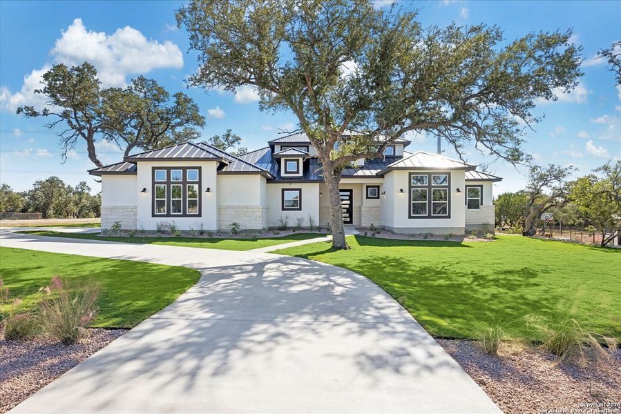 Front exterior of a new home in , Bulverde, TX, highlighting curb appeal (Image 30).
