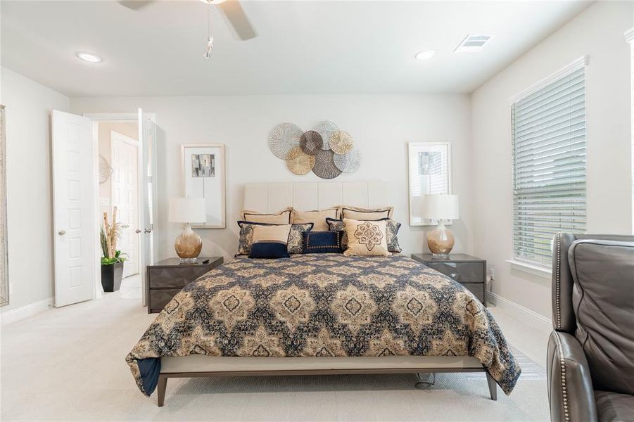 Bedroom featuring light carpet, a ceiling fan, and recessed lighting