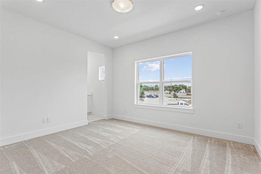 Unfurnished room with light carpet