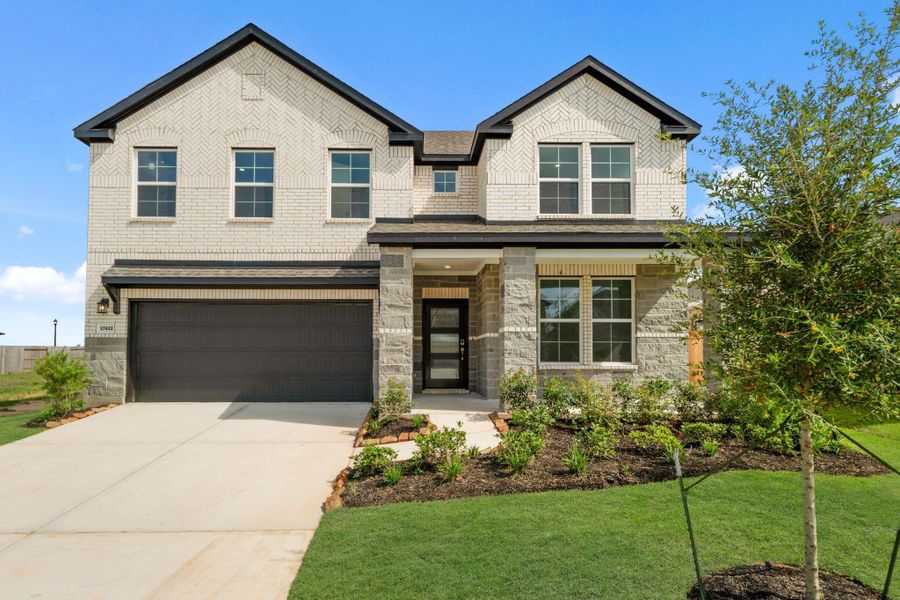 Front exterior of a new home in Sunterra, Katy, TX, highlighting curb appeal (Image 17). Front exterior of a new home in Sunterra, Katy, TX, highlighting curb appeal (Image 17).