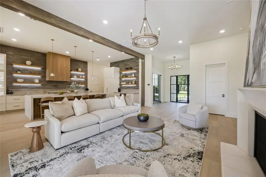 LIVING ROOM II: Designed for effortless entertaining, the open-concept living area flows seamlessly into the kitchen and is wired for sound in both the living room and kitchen.