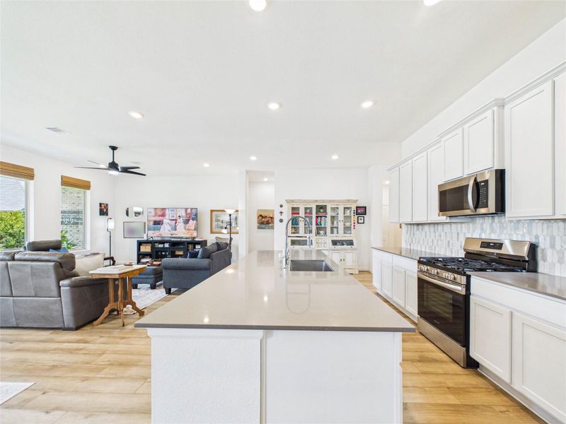 The oversized kitchen island provides the perfect gathering spot with plenty of room for barstool seating, casual dining, and everyday conversation. It also offers generous prep space, making it ideal for the chef of the home to cook, serve, and entertain with ease.