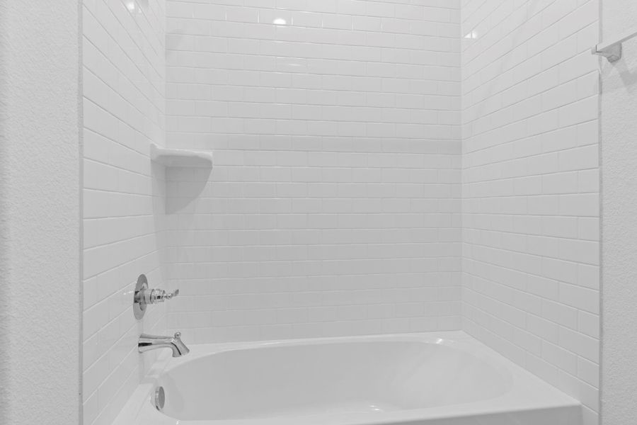 Guest bathroom with large deep tub and shower combination.  Tile surrounding and more!
