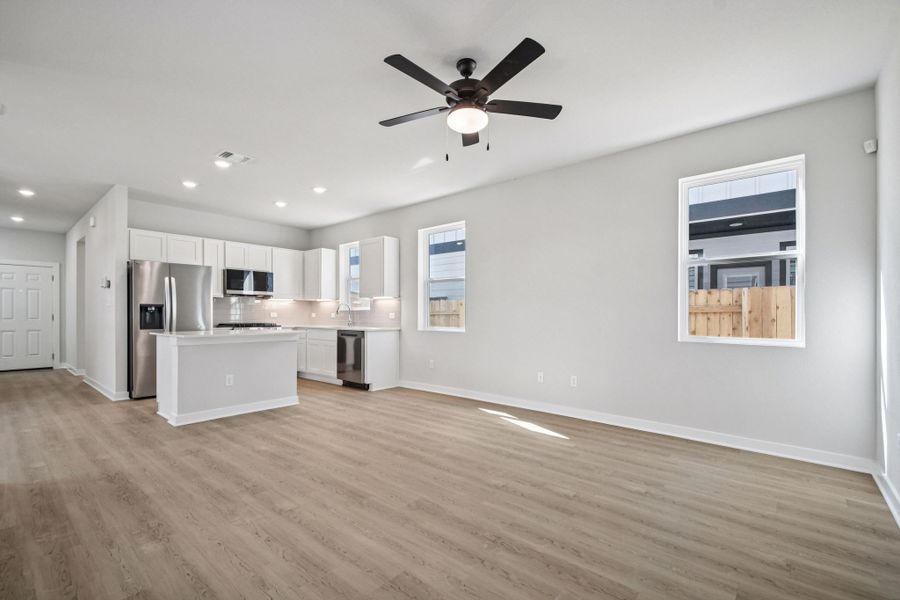 A kitchen with white cabinets.