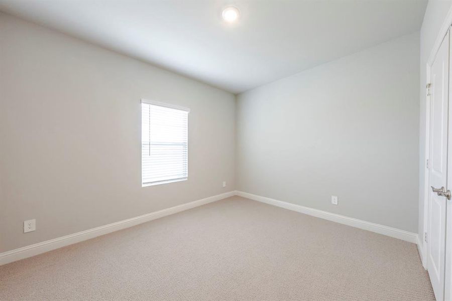 Spare room featuring light colored carpet and recessed lighting Spare room featuring light colored carpet and recessed lighting