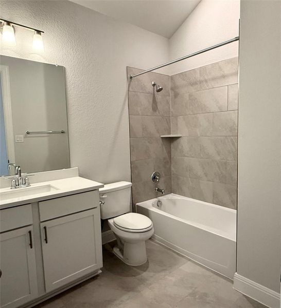 Full bath featuring vanity, shower / washtub combination, and a textured wall Full bath featuring vanity, shower / washtub combination, and a textured wall