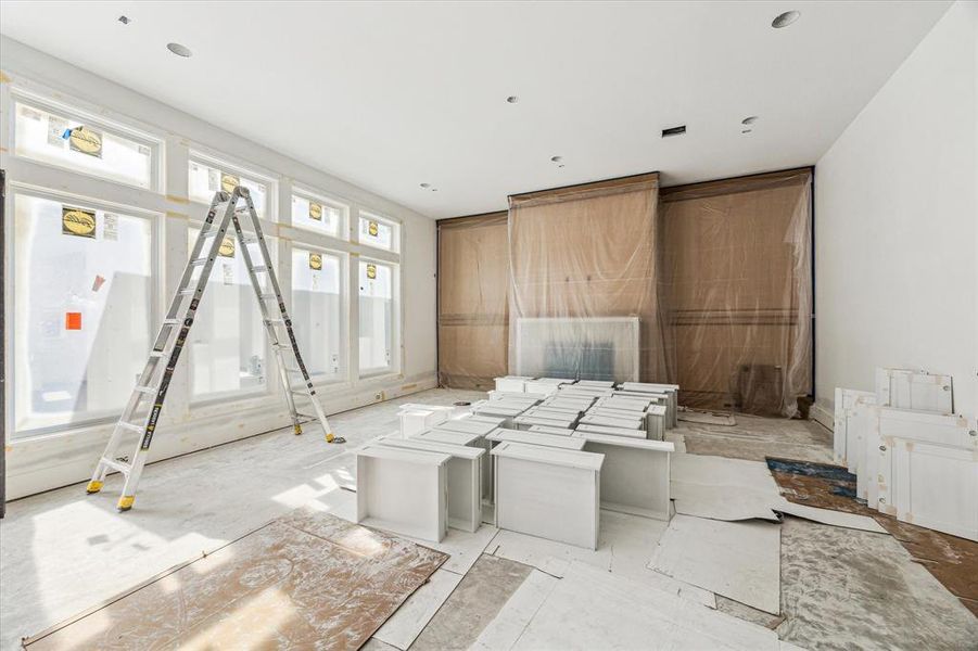 Living room with floor to ceiling windows.  The wall of white-oak is beautifully accented with the cast-stone fireplace.  Construction as of 10/29