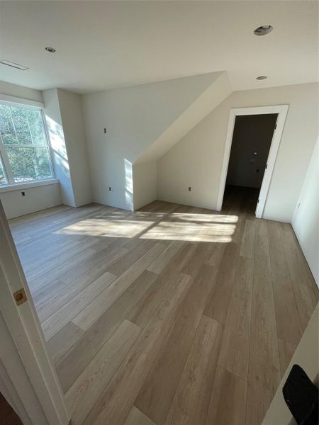 Light-filled upstairs bedroom with angled ceilings and large window overlooking the treetops, offering privacy and versatility as a guest room or even a second primary suite. Light-filled upstairs bedroom with angled ceilings and large window overlooking the treetops, offering privacy and versatility as a guest room or even a second primary suite.