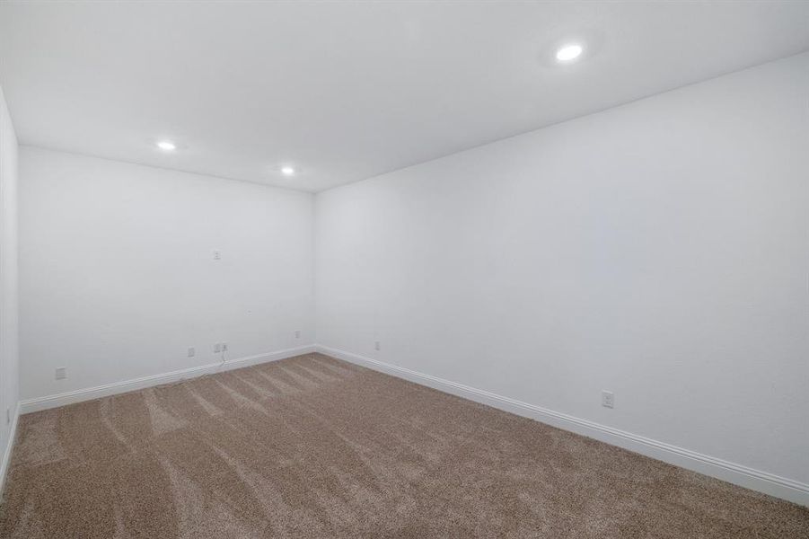 Spare room with light carpet, baseboards, and recessed lighting