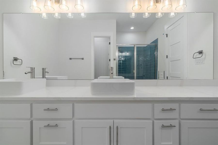 Bathroom with an enclosed shower and double sink vanity