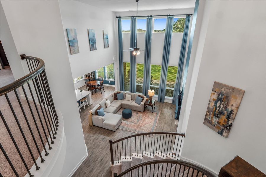 Living area with wood finished floors and stairway Living area with wood finished floors and stairway