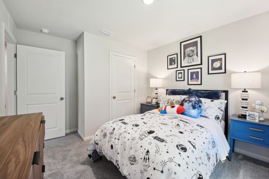 A bedroom with a bed and a dresser. A bedroom with a bed and a dresser.