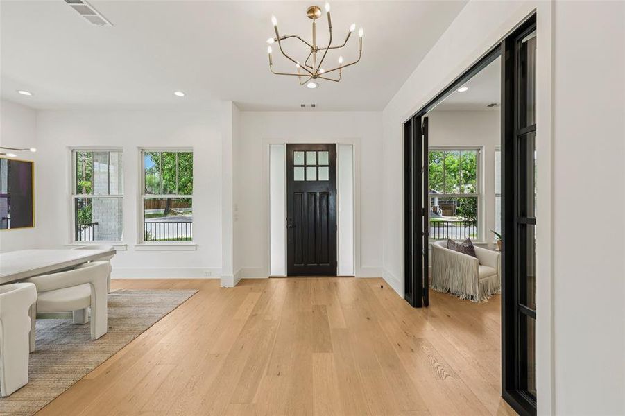 Entryway with light wood-finish flooring and white walls