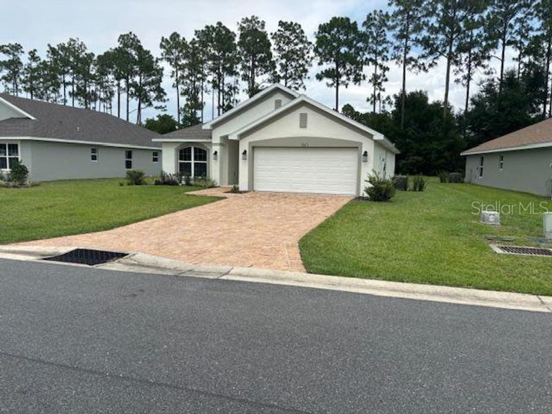 Front exterior of a new home in Juliette Falls, Dunnellon, FL, highlighting curb appeal (Image 10).