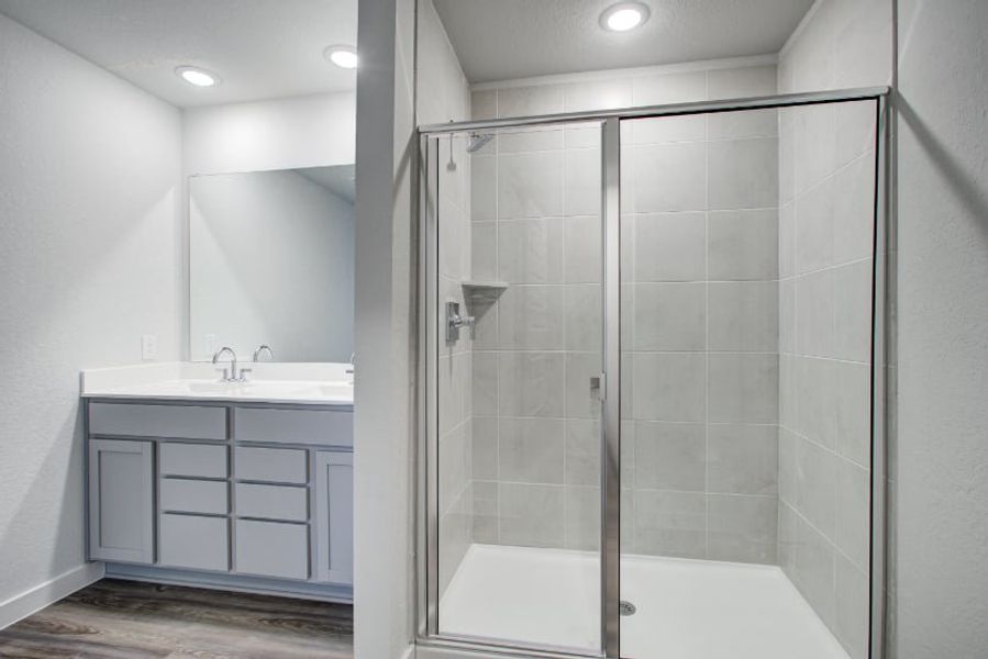 A bathroom with a glass shower. A bathroom with a glass shower.