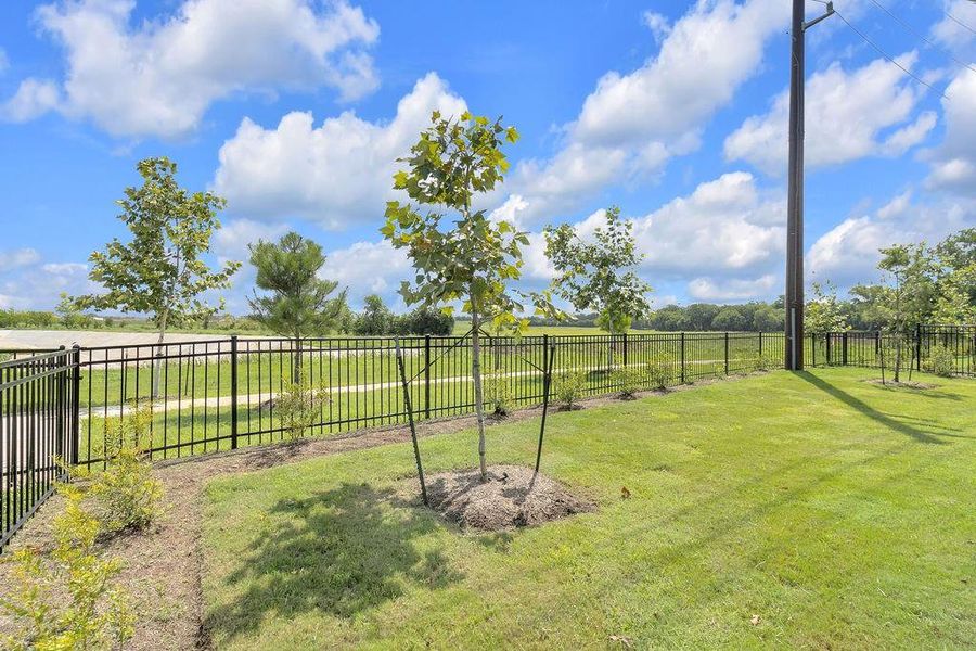 Imagine stepping into a serene, expansive backyard with a direct view of a sparkling lake.  Your very own slice of heaven!