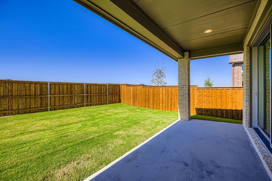 Fenced backyard featuring a patio