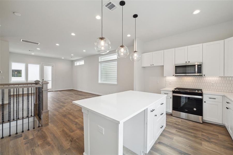 Enjoy modern living with this open-concept design that seamlessly connects the kitchen and dining area to the living room. This layout creates a spacious and inviting atmosphere perfect for entertaining guests or enjoying everyday family life.