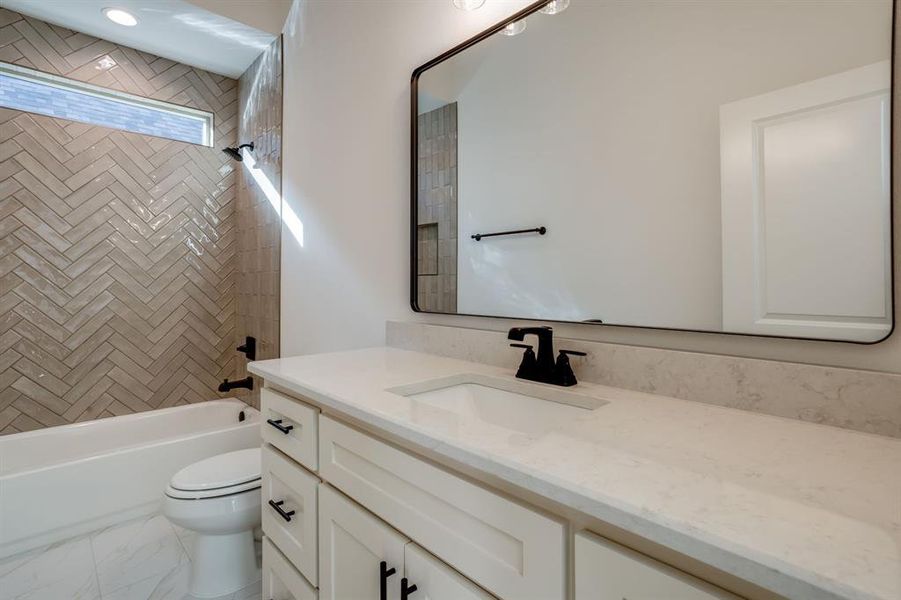 Full bath featuring vanity and  shower combination