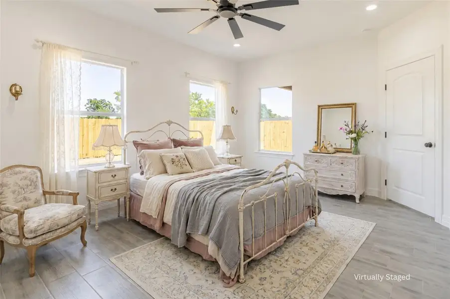 The primary bedroom is filled with natural light thanks to the perfectly placed windows. The primary bedroom is filled with natural light thanks to the perfectly placed windows.