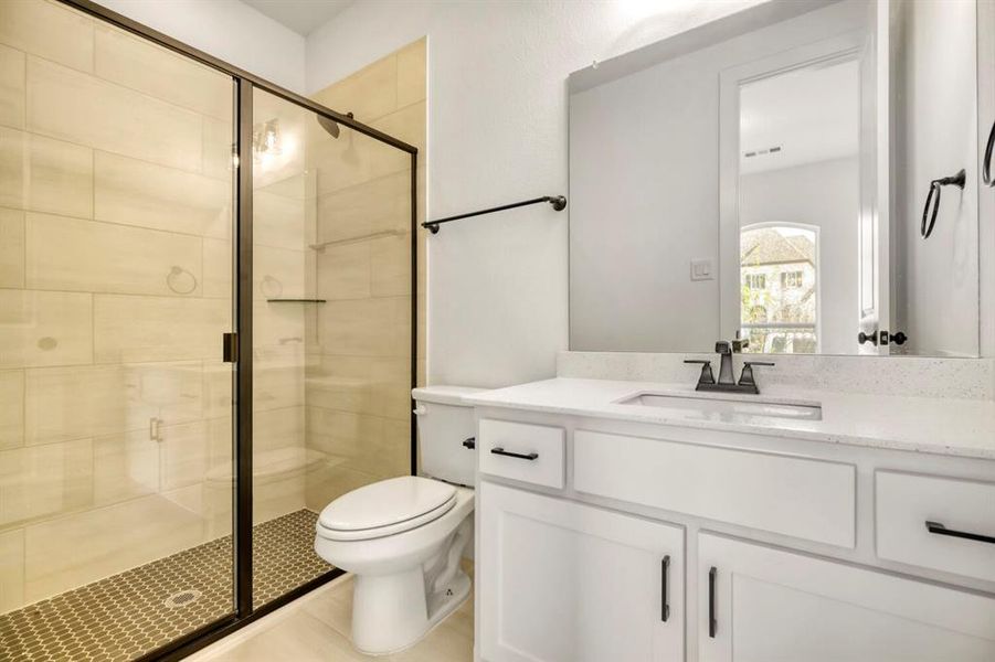 Full bath featuring a stall shower and vanity