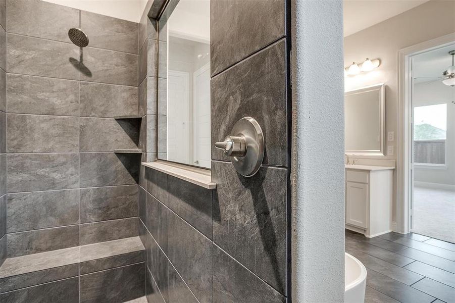 Bathroom with ceiling fan, plus walk in shower, and wood-type flooring