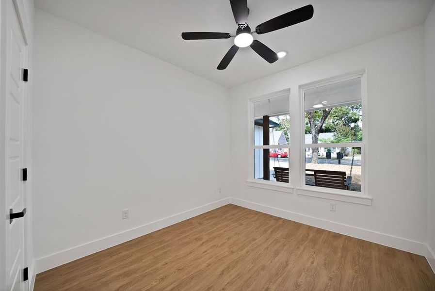 Unfurnished room with light wood-type flooring and a ceiling fan