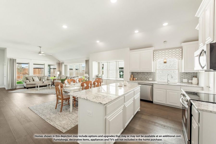 Open-concept kitchen with white cabinets, granite island, and hardwood floors opening to living area Open-concept kitchen with white cabinets, granite island, and hardwood floors opening to living area