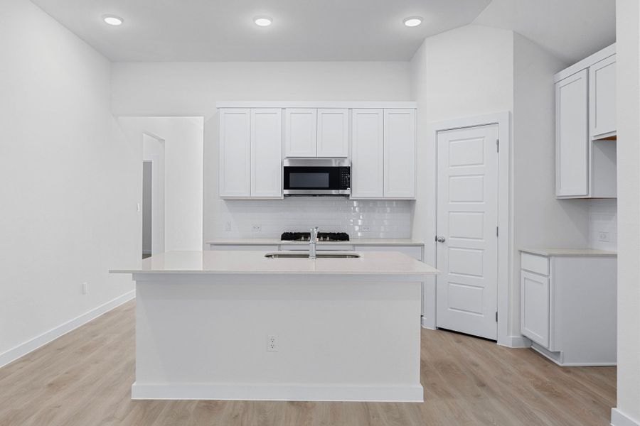 Kitchen in the Cypress home plan by Trophy Signature Homes - REPRESENTATIVE PHOTO
