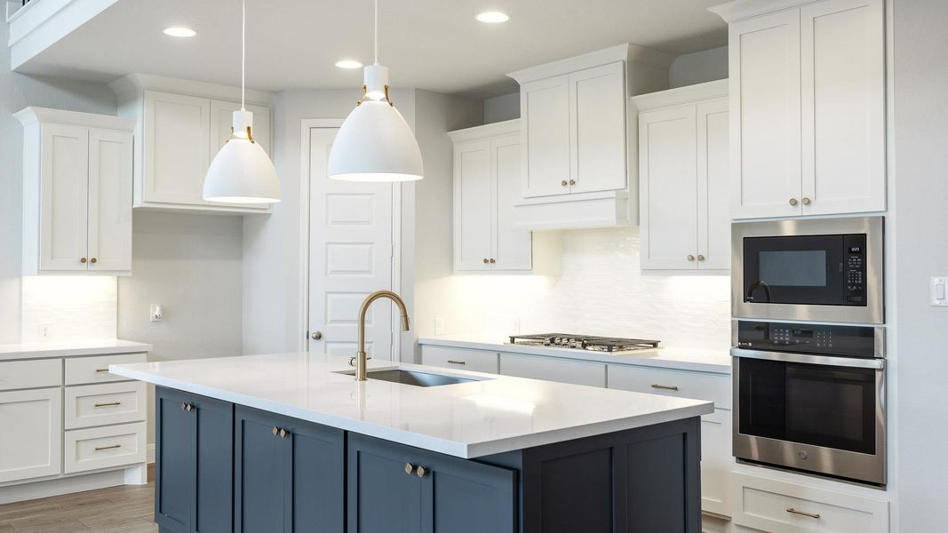 Kitchen featuring decorative backsplash, white cabinetry, stainless steel appliances, light stone counters, and recessed lighting