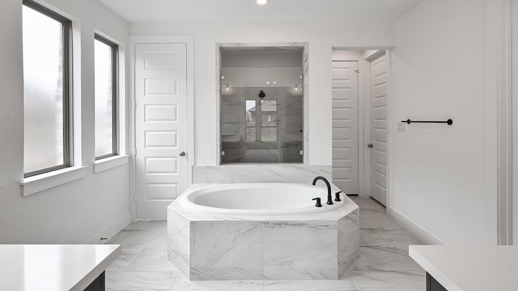 Full bathroom featuring vanity, baseboards, a bath, and marble finish floor