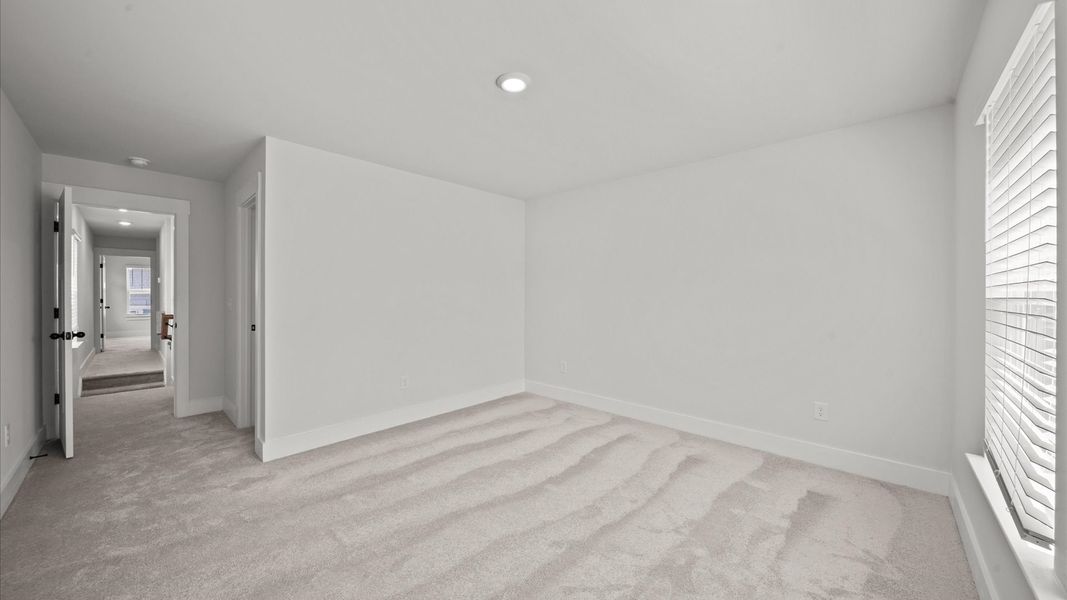 Superior comfort in this light-filled bedroom with plush carpeting and thoughtfully placed large windows