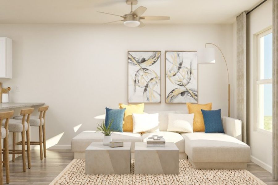 A living room with a white couch and a table.