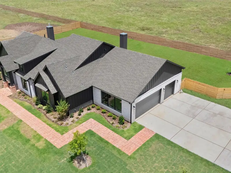 Front exterior of a new home in , Smithville, TX, highlighting curb appeal (Image 27).