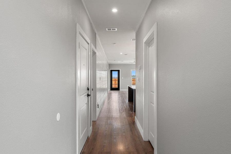 Hall with recessed lighting, dark wood-type flooring, and ornamental molding
