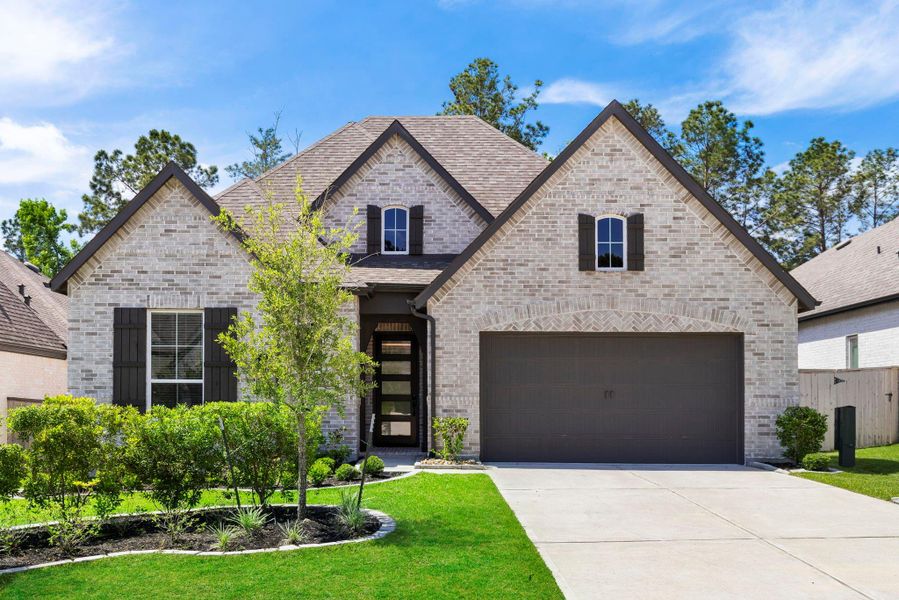 Front exterior of a new home in Woodforest, Montgomery, TX, highlighting curb appeal (Image 27).