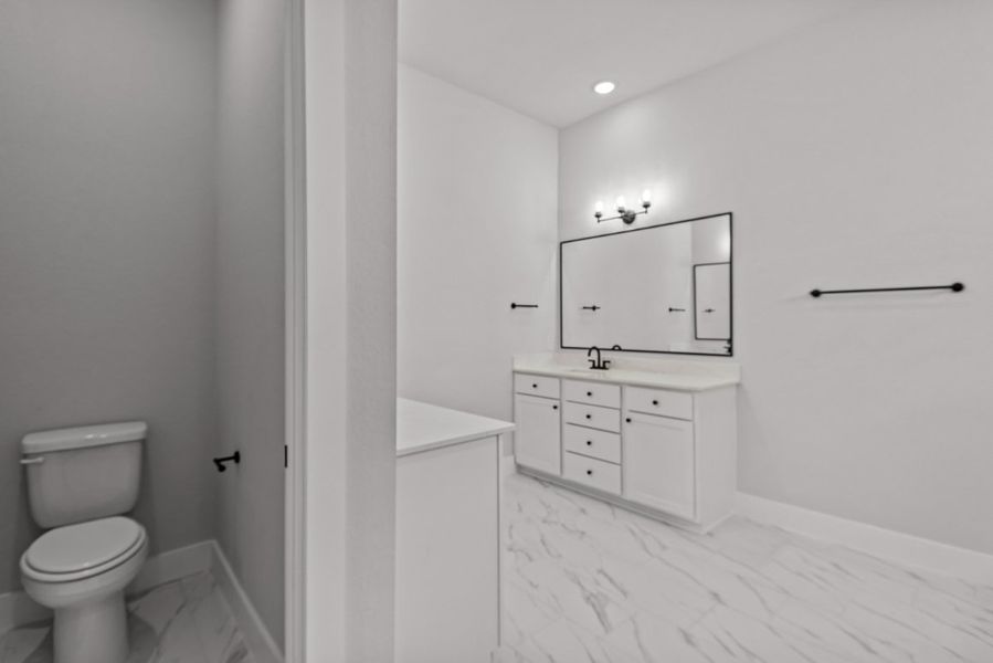 A bathroom with white tiles.
