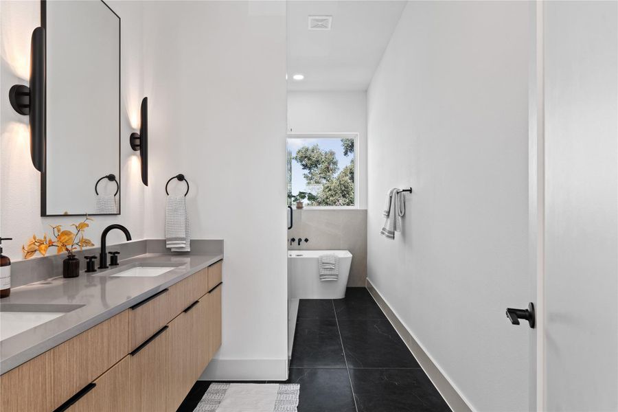 The ensuite is grounded by large-format tile that adds a refined, modern presence. The ensuite is grounded by large-format tile that adds a refined, modern presence.