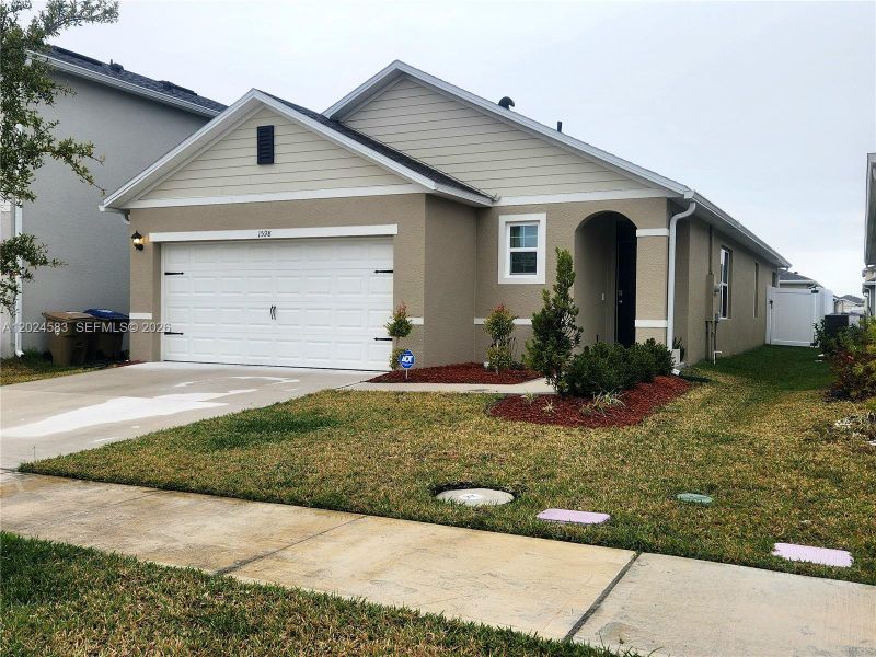 Front exterior of a new home in Kindred, Kissimmee, FL, highlighting curb appeal (Image 1). Front exterior of a new home in Kindred, Kissimmee, FL, highlighting curb appeal (Image 1).