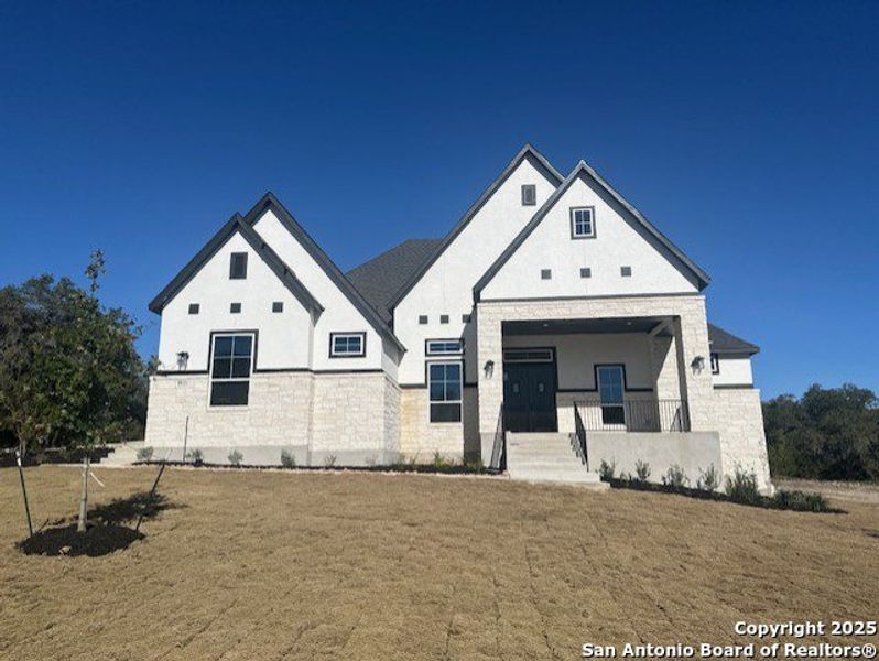 Front exterior of a new home in Heimer Estates at Garden Ridge, San Antonio, TX, highlighting curb appeal (Image 1).