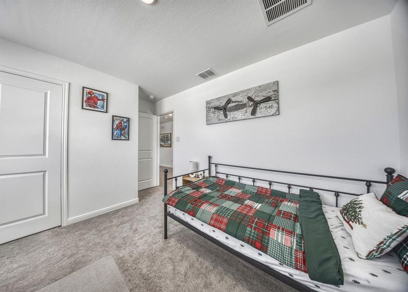 Carpeted room featuring white walls, white trim, and two paneled doors Carpeted room featuring white walls, white trim, and two paneled doors