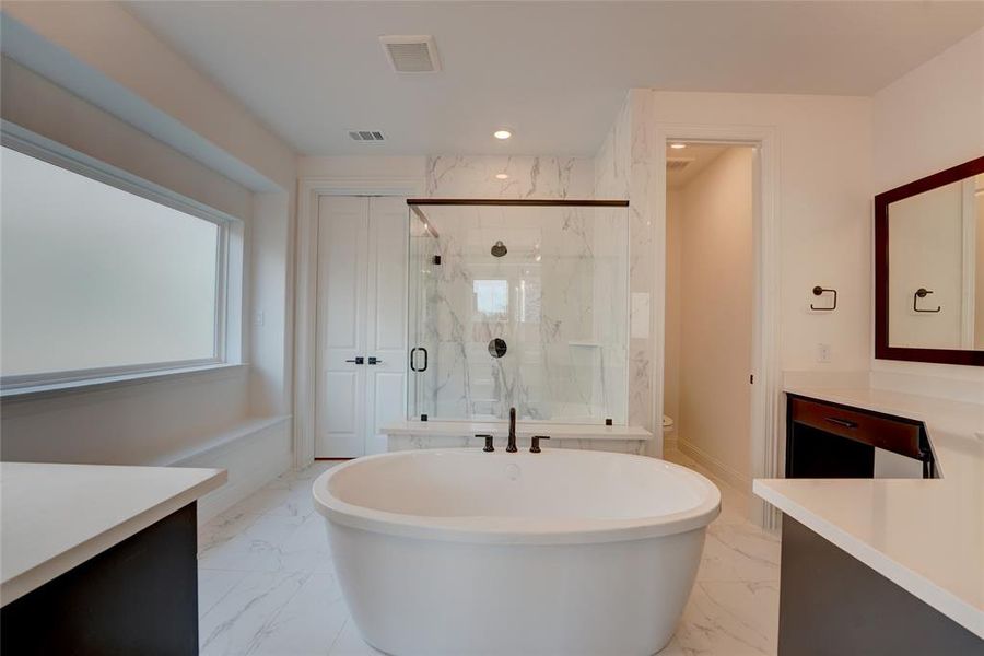 Full bathroom featuring marble finish floor, a marble finish shower, visible vents, and vanity