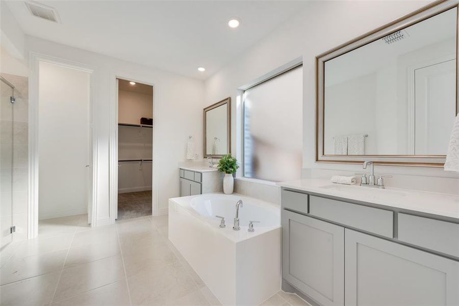 Bathroom featuring vanity, tile patterned floors, and independent shower and bath